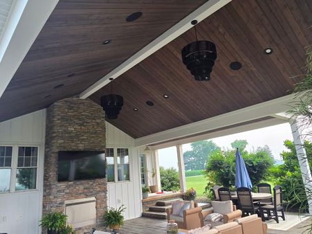outdoor living space with a stone fireplace, wood ceiling and patio furniture